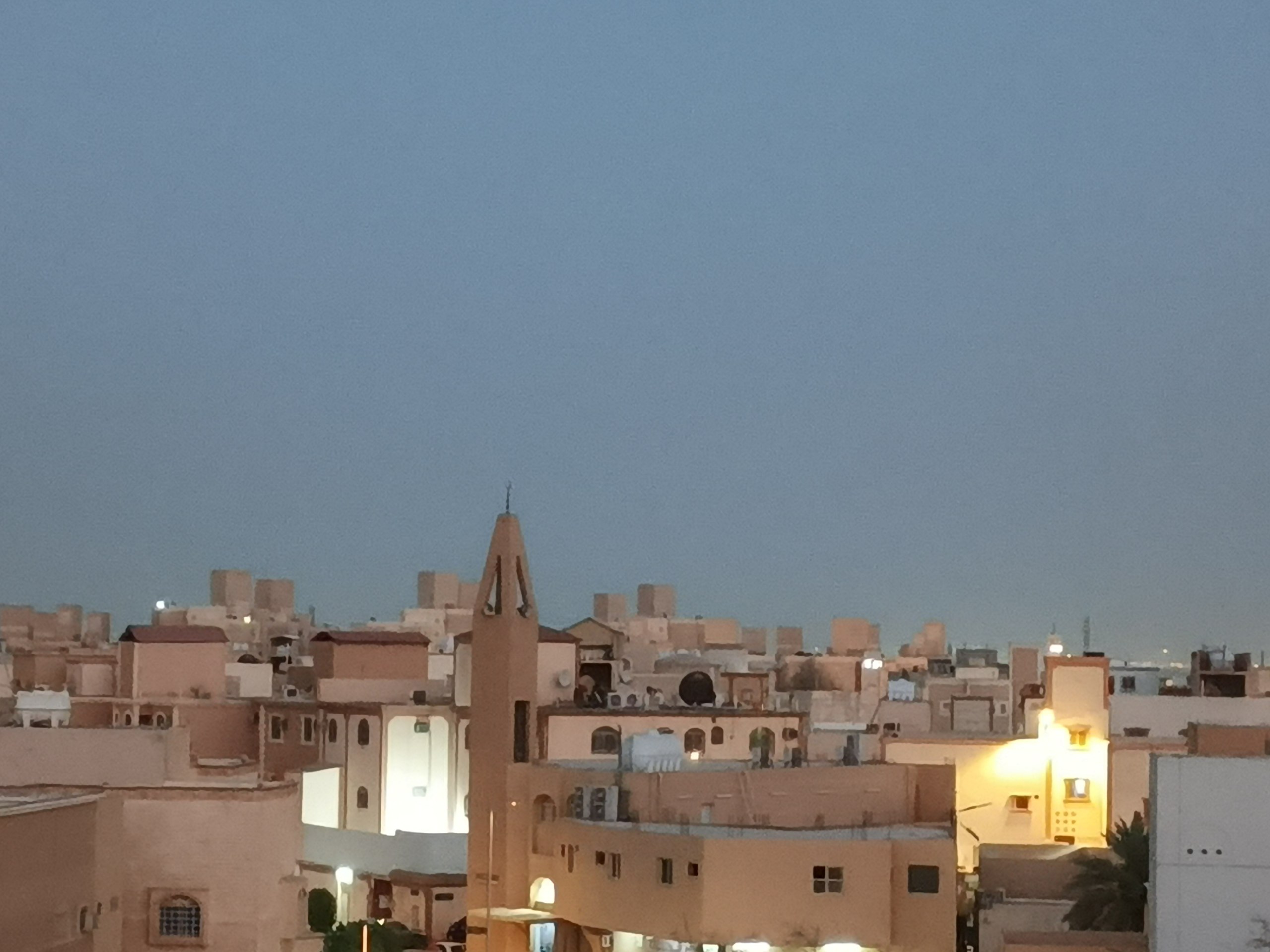 Lit windows across office and apartment towers in Riyadh at night